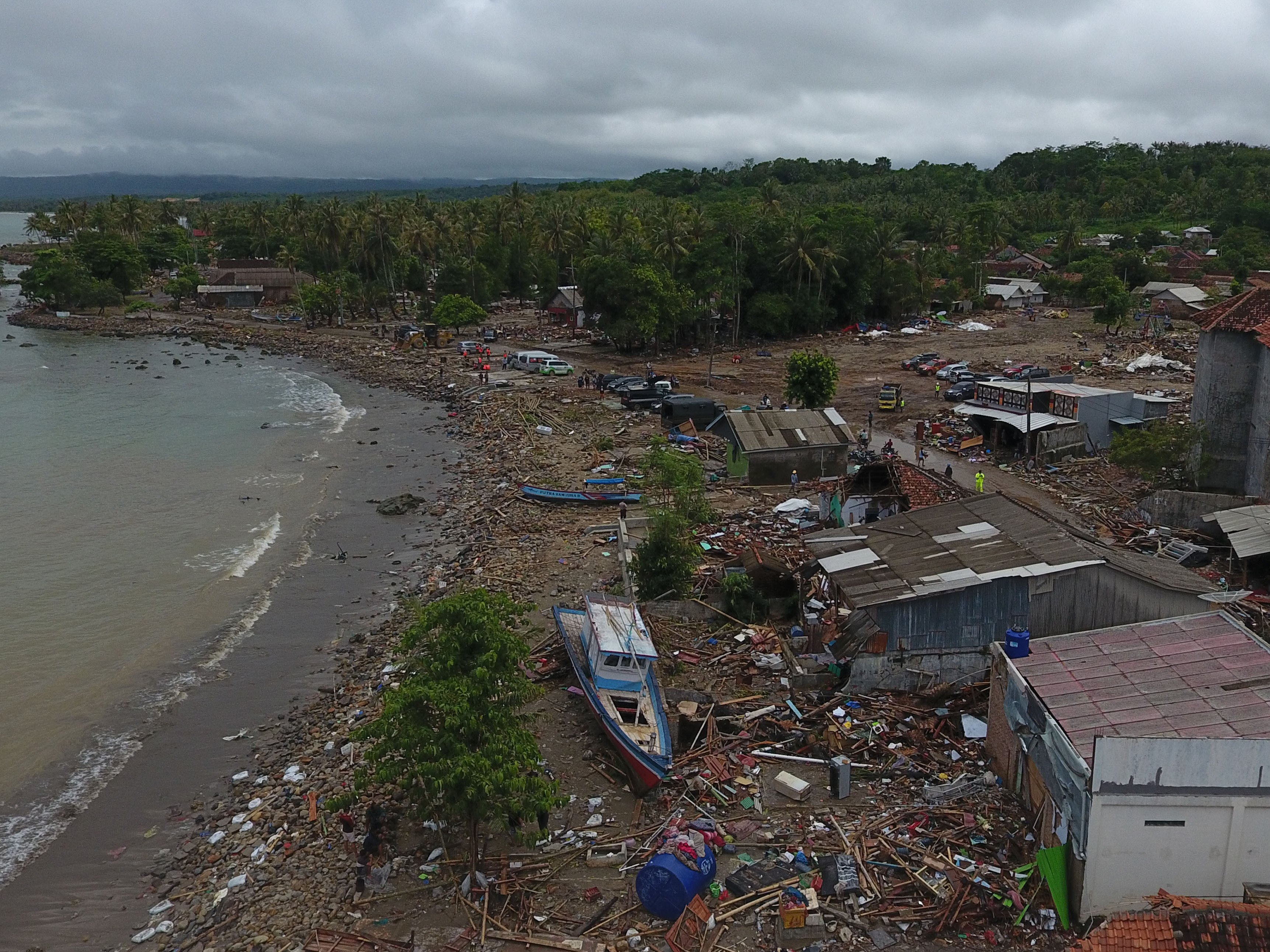 caption: Damaged houses, boats and debris are seen after a tsunami in this aerial photo taken in Sumur, Pandeglang, Banten province, Indonesia, on Tuesday. The death toll from a tsunami now exceeds 400.