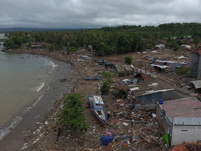 caption: Damaged houses, boats and debris are seen after a tsunami in this aerial photo taken in Sumur, Pandeglang, Banten province, Indonesia, on Tuesday. The death toll from a tsunami now exceeds 400.