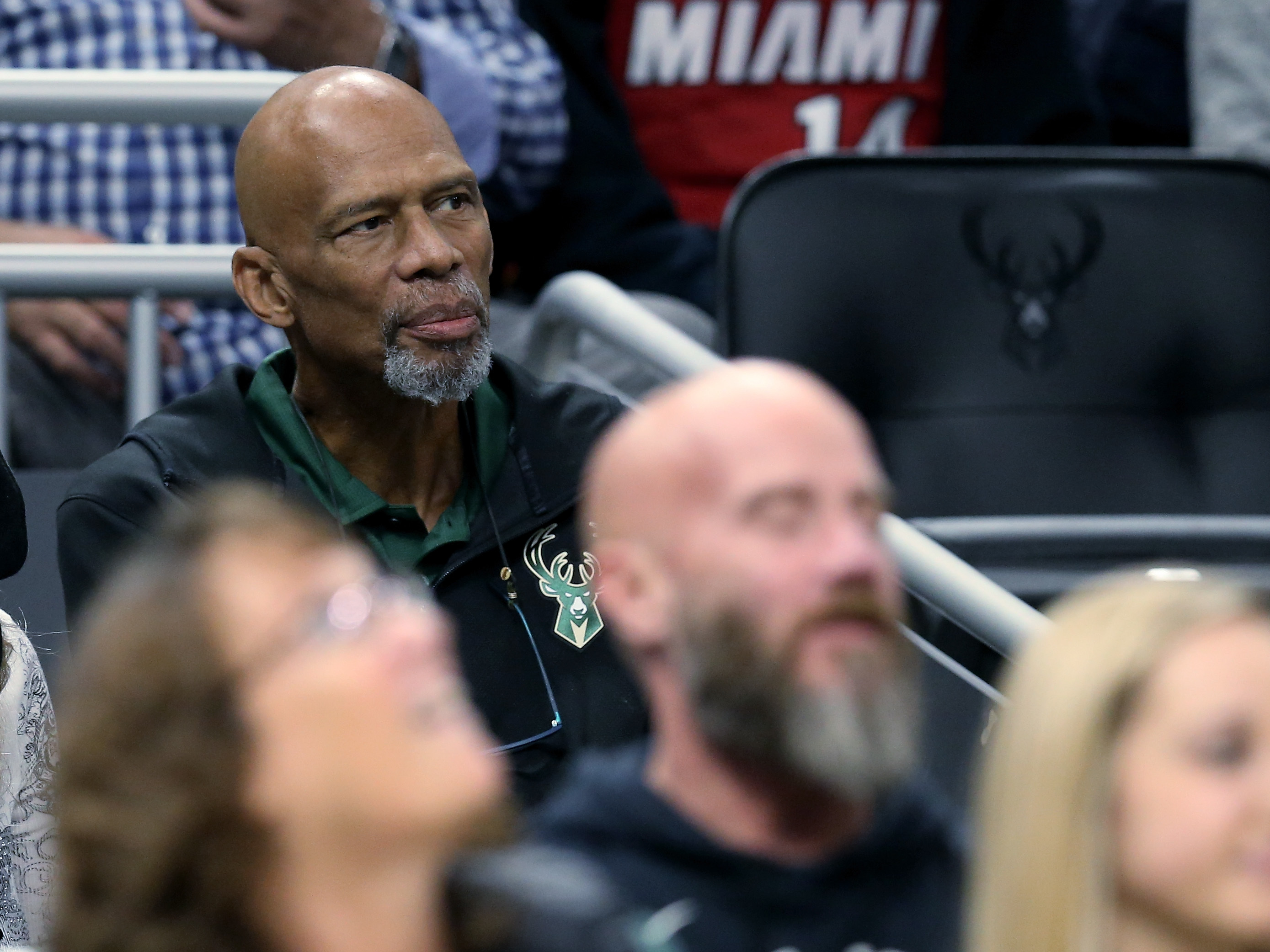 caption: NBA Hall of Famer Kareem Abdul-Jabbar looks on during the game between the Miami Heat and Milwaukee Bucks at the Fiserv Forum in 2019 in Milwaukee, Wisconsin.
