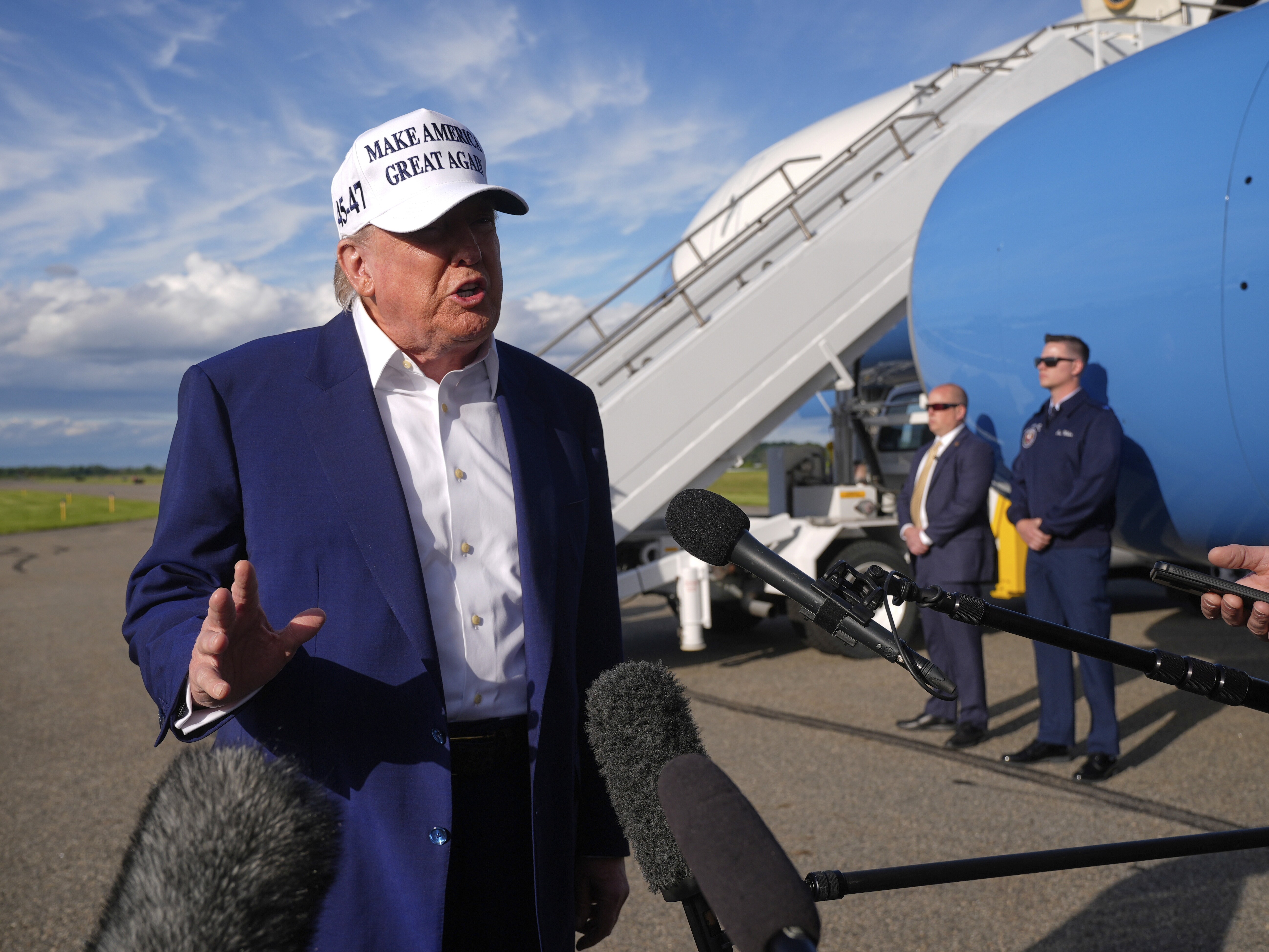 caption: President Trump speaks to reporters before boarding Air Force One at Morristown Municipal Airport in Morristown, N.J., on Sunday.