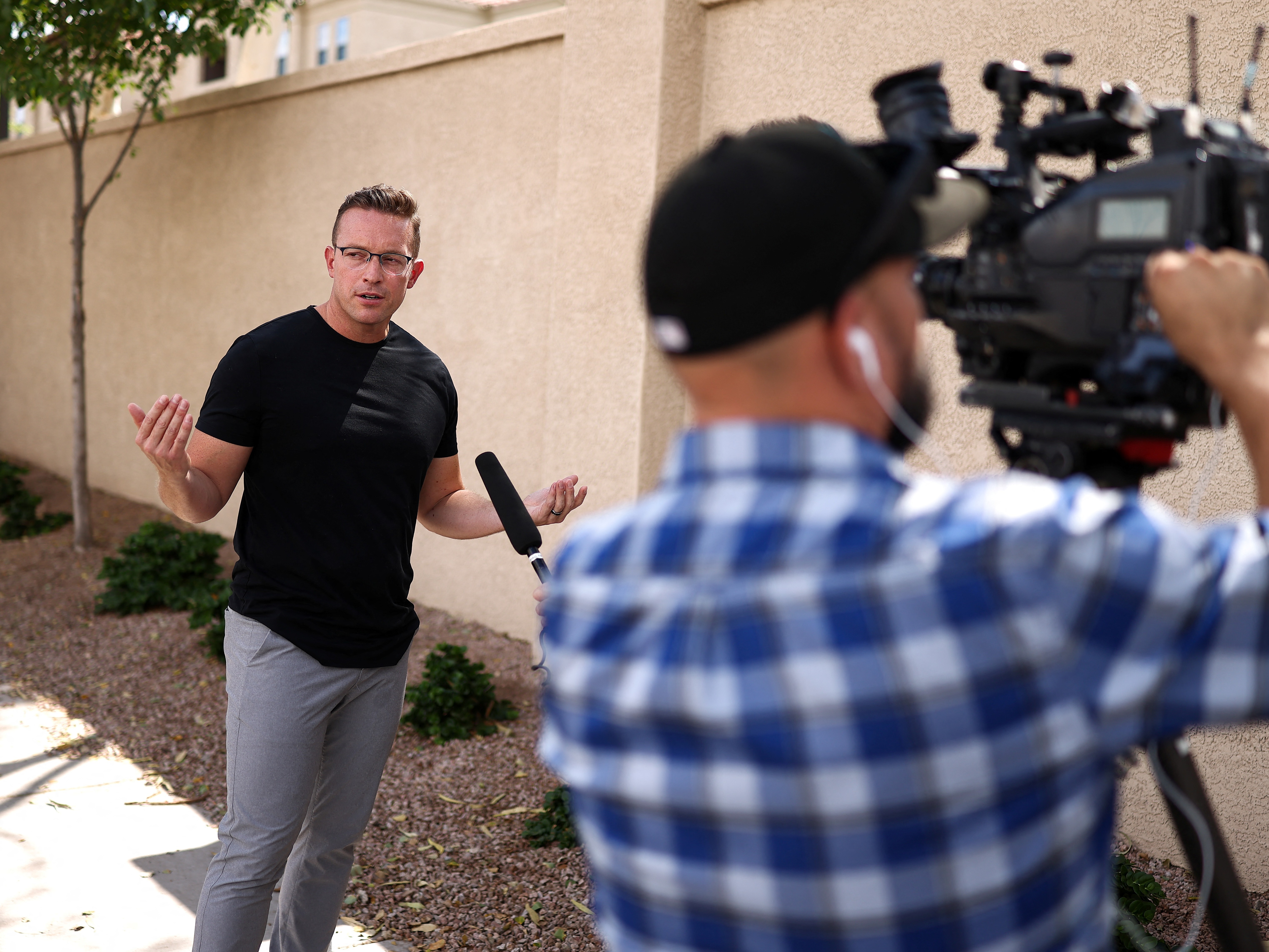 caption: Pro-Trump influencer and YouTuber Benny Johnson being interviewed in Phoenix earlier this year. Johnson is one of many political influencers with close ties to the Trump administration.