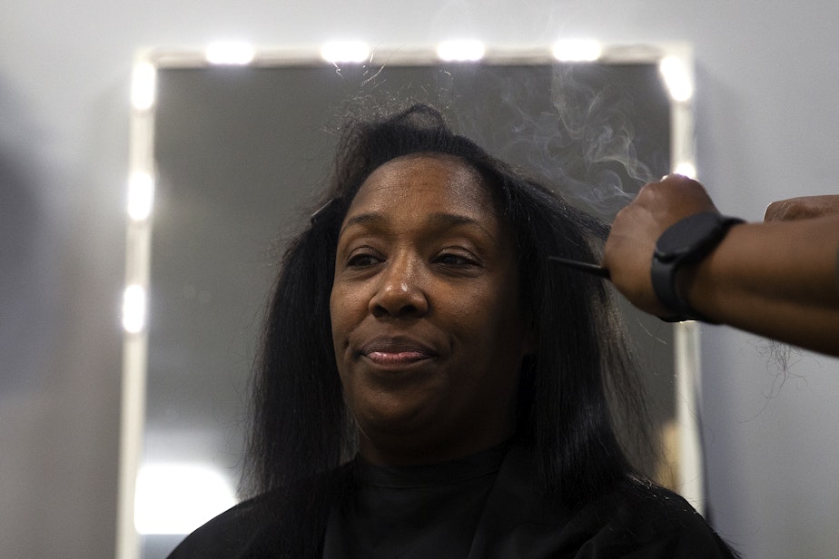 caption: Nina Trapp straightens DaVonna Johnson’s hair during an appointment at Mati’s Salon and Barbershop on Friday, May 24, 2024, along Rainier Avenue South in Seattle. 