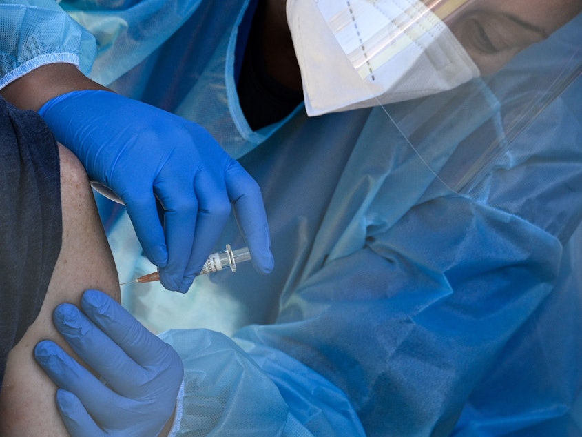 caption: A flu vaccine is administered at a walk-up COVID-19 testing site, in San Fernando, Calif. Emergency use authorization is expected soon for vaccines for COVID-19.