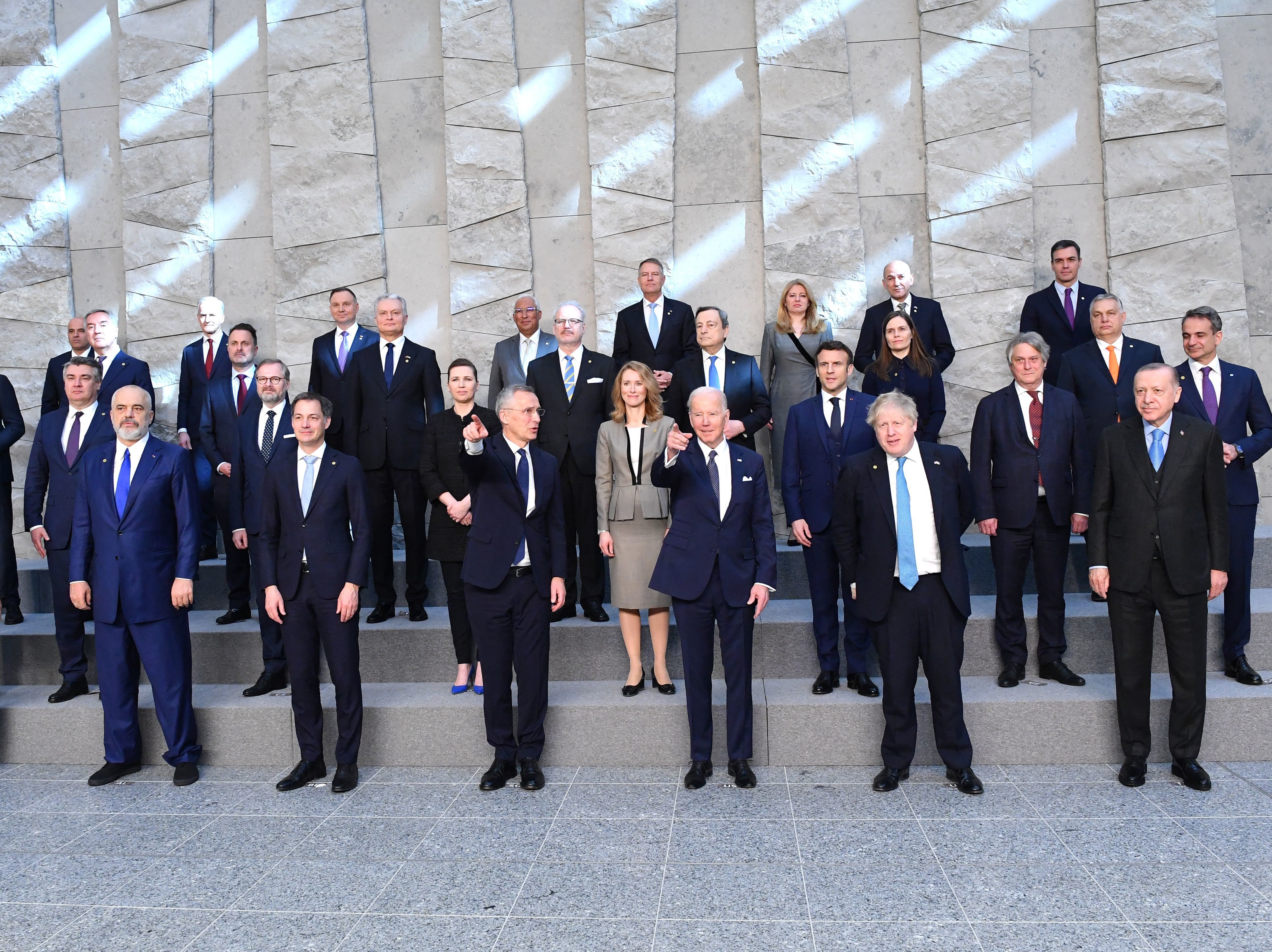 caption: Leaders of NATO member nations pose for a family photo at NATO Headquarters in Brussels on March 24.