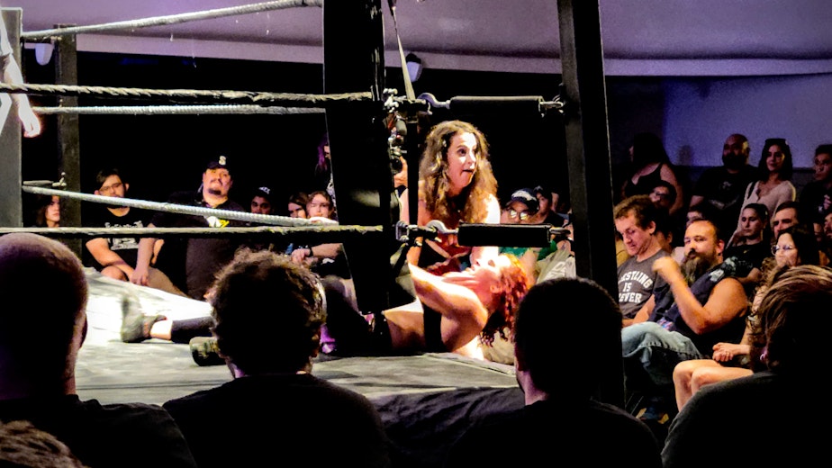 caption: Nicole Matthews pulls Masha Slamovich out of the ring during DEFY Wrestling's "Violent Minds"