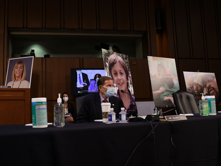 caption: Democrats on the Senate Judiciary Committee display photos of people who have been impacted by the Affordable Care Act, as the lawmakers argue that confirming Amy Coney Barrett to the Supreme Court would be detrimental to health care.