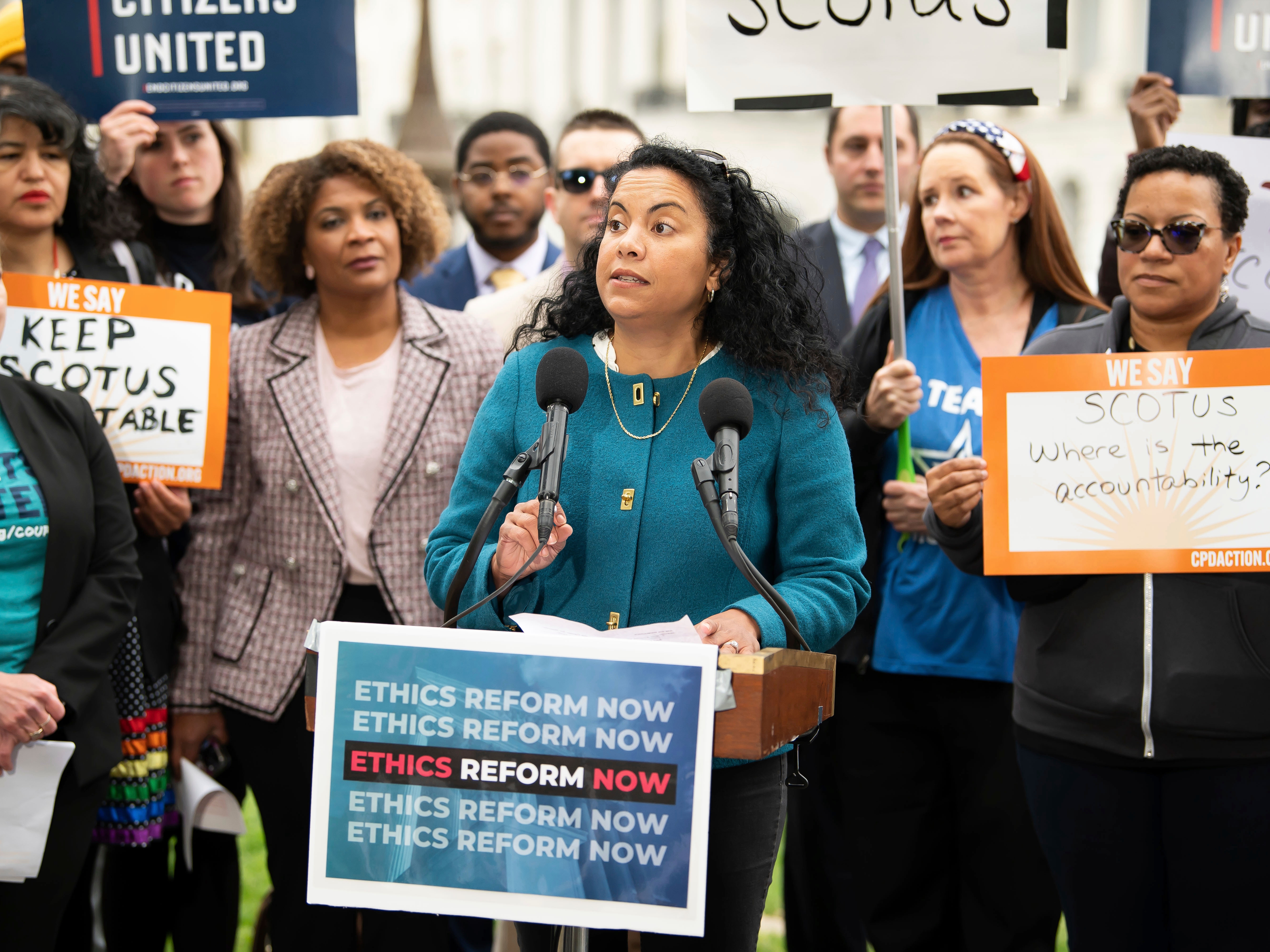 caption: FILE - Analilia Mejia, center, speaks during a rally calling for SCOTUS ethics reform, May 2, 2023, in Washington.