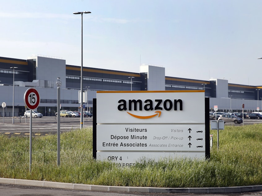caption: The entrance of Amazon's logistics center in Bretigny-sur-Orge, one of six Amazon facilities in France.