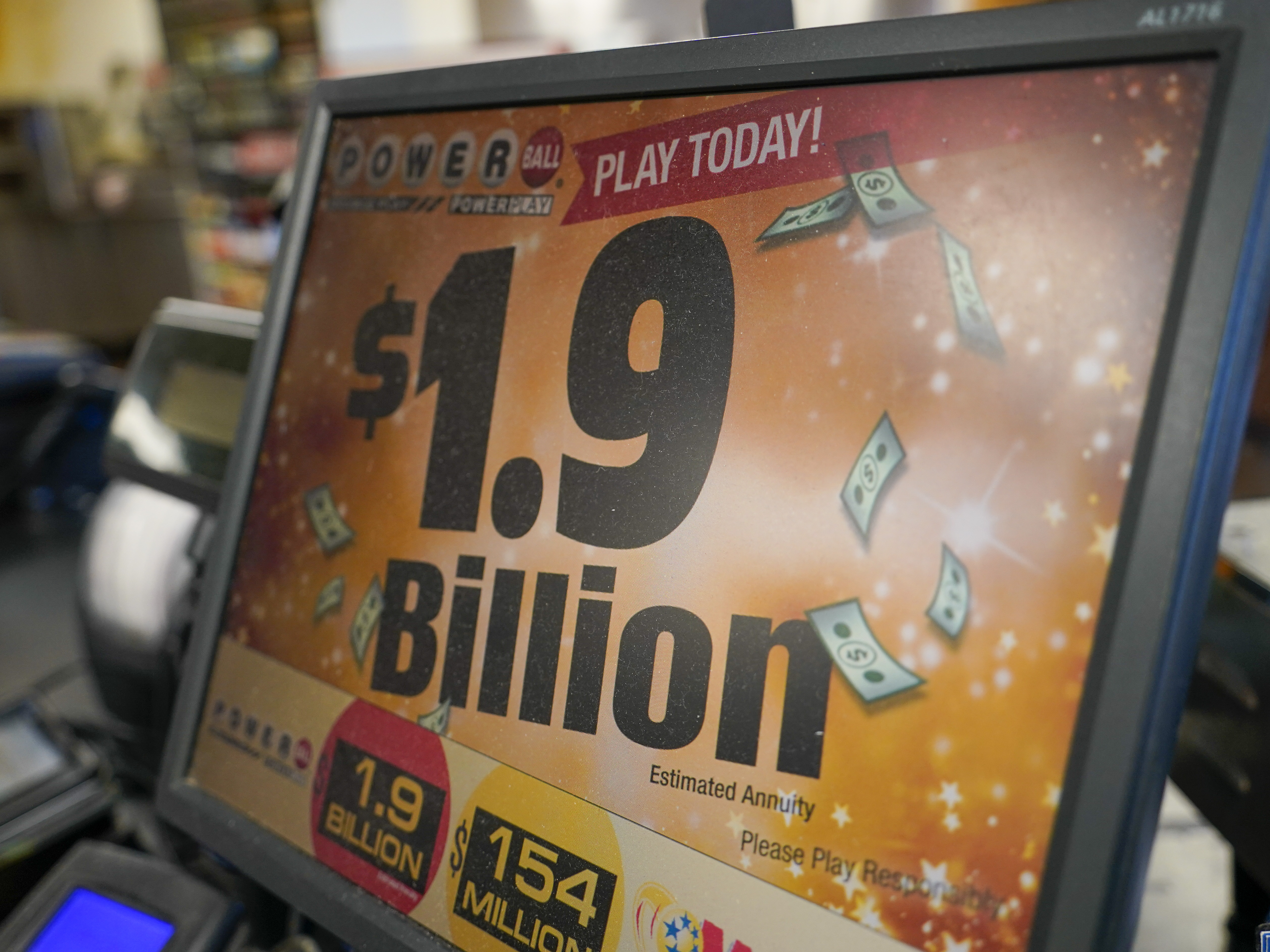 caption: The display panel advertising the tickets for the Monday Powerball drawing with an annuity value of at least $1.9 billion, are shown at a convenience store, Monday, Nov. 7, 2022, in Renfrew, Pa.