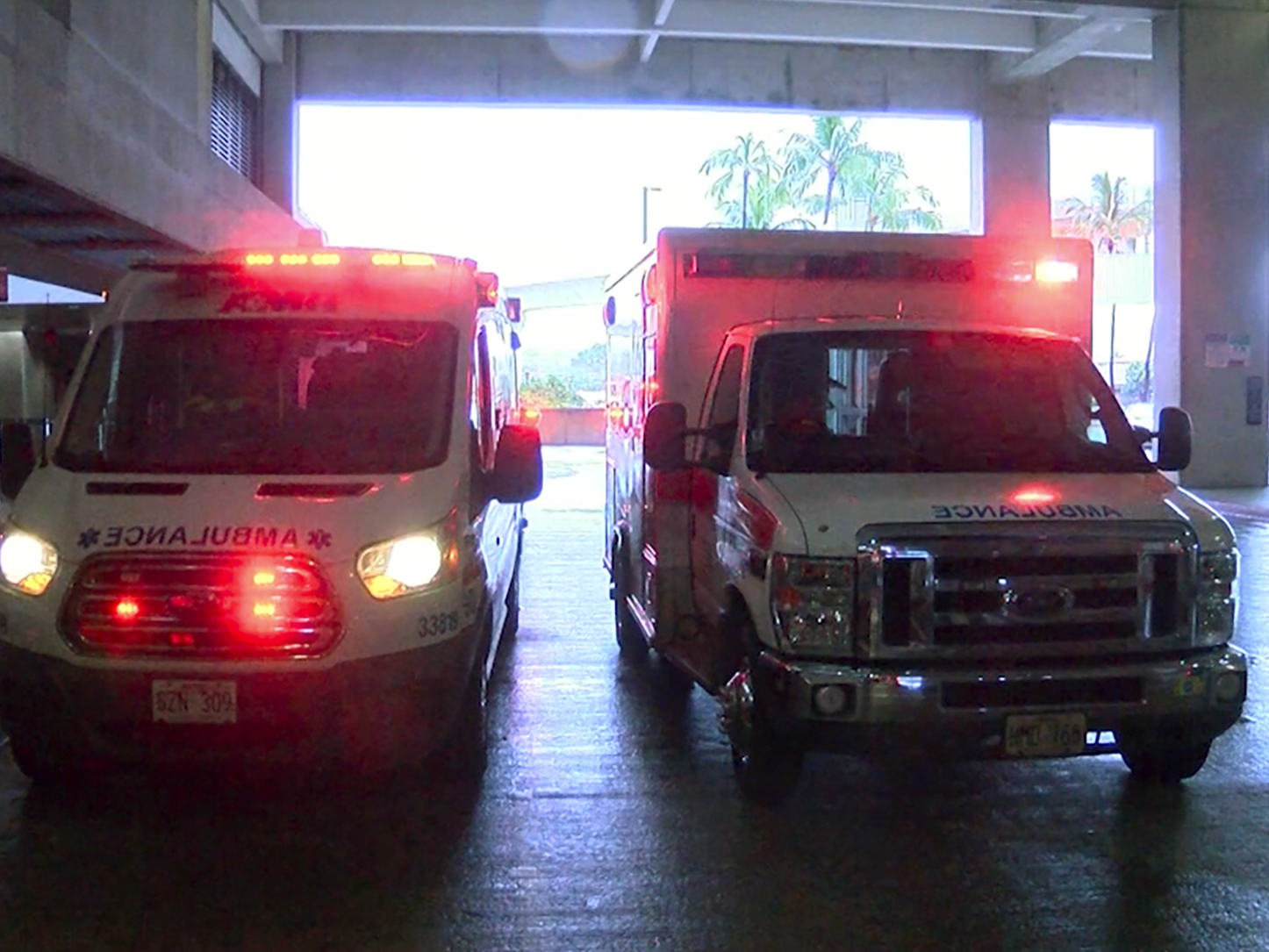 caption: In this image taken from a video provided by Hawaii News Now, ambulances remain outside the international airport in Honolulu after multiple people were seriously injured when a flight to Hawaii hit severe turbulence  Sunday.