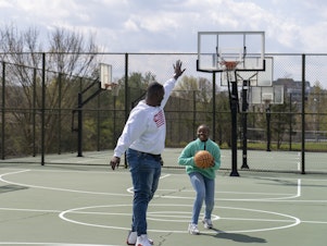 caption: Joseph Yusuf plays basketball with his daughter, Jakayla Morton, 11, in Alexandria, Va., on March 29.