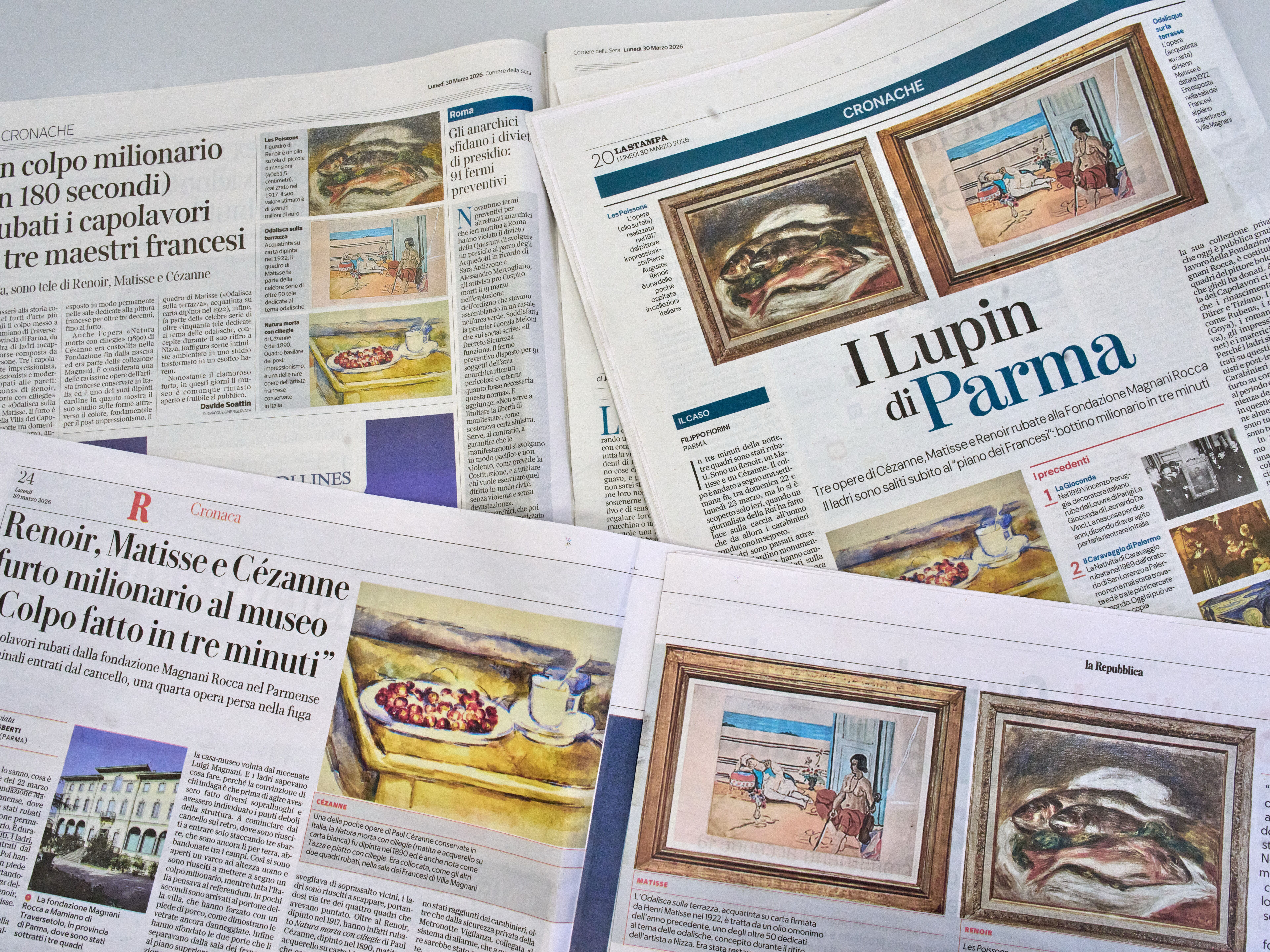 caption: Italian Newspapers carry the news of the heist of three paintings, "Fish" by Auguste Renoir, "Still Life with Cherries" by Paul Cézanne, and "Odalisque on the Terrace" by Henri Matisse, from a museum near Parma, northern Italy, Monday, March 30, 2026.