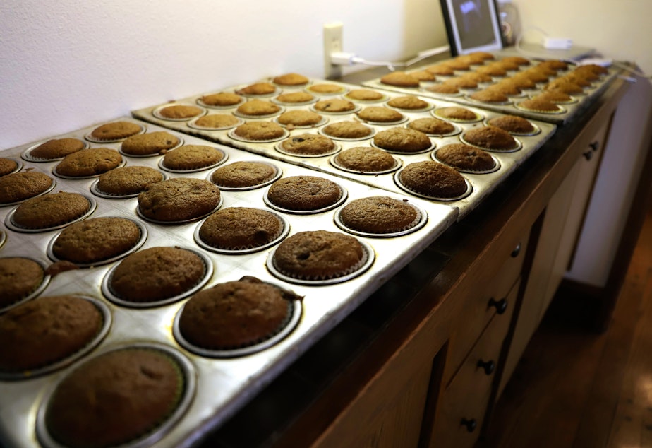 caption: Lanne Stauffer's pumpkin cranberry muffins cooling before they're bagged and stocked in her little free bakery. 