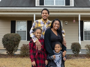 caption: Nicole Howson and her family stand in front of their new home in Griffin, Ga. Clockwise: Nicole Howson, Israel Epps, Talysa Epps and Latroun Epps.