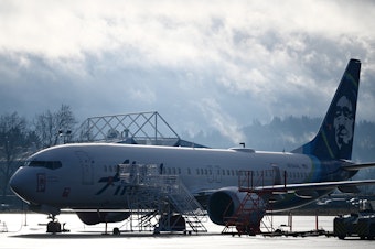 caption: Alaska Airlines N704AL, a 737 Max 9, which made an emergency landing at Portland International Airport on January 5 is parked at a maintenance hanger in Portland, Ore. on January 23, 2024. One of two door plugs on the emergency exit door blew out shortly after the plane took off from Portland.