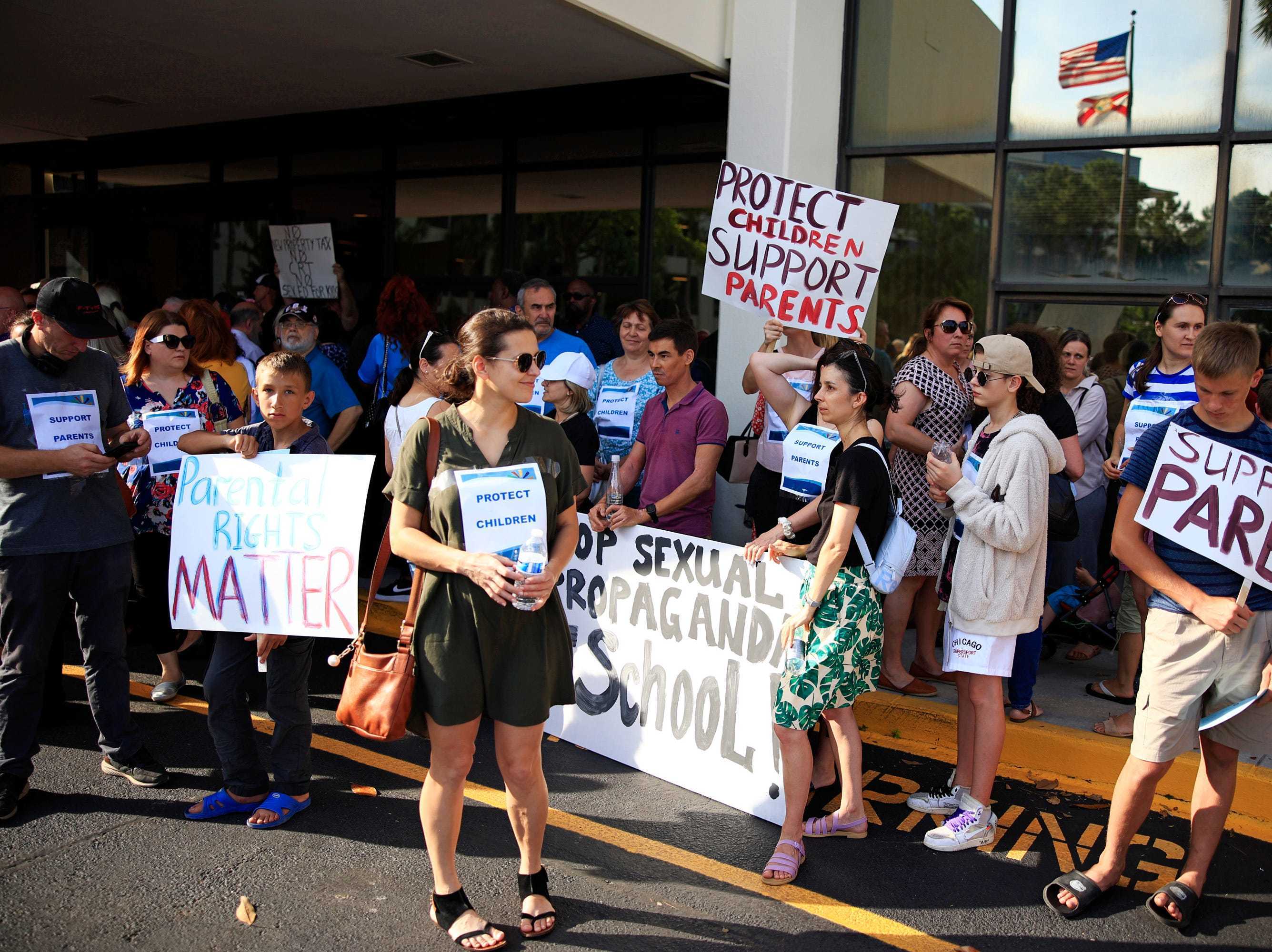 caption: Supporters of Florida's recently signed Parental Rights in Education law demonstrate at the Duval County Public Schools building in Jacksonville, Fla., on May 3.
