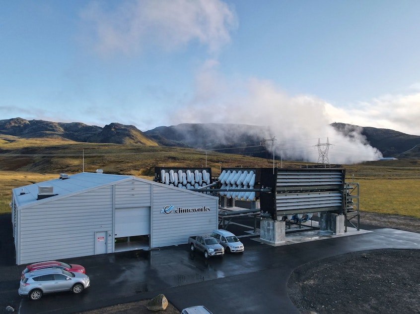 caption: Climeworks factory with it's fans in front of the collector, drawing in ambient air and release it, as largely purified CO2 through ventilators at the back is seen at the Hellisheidi power plant near Reykjavik on October 11, 2021.