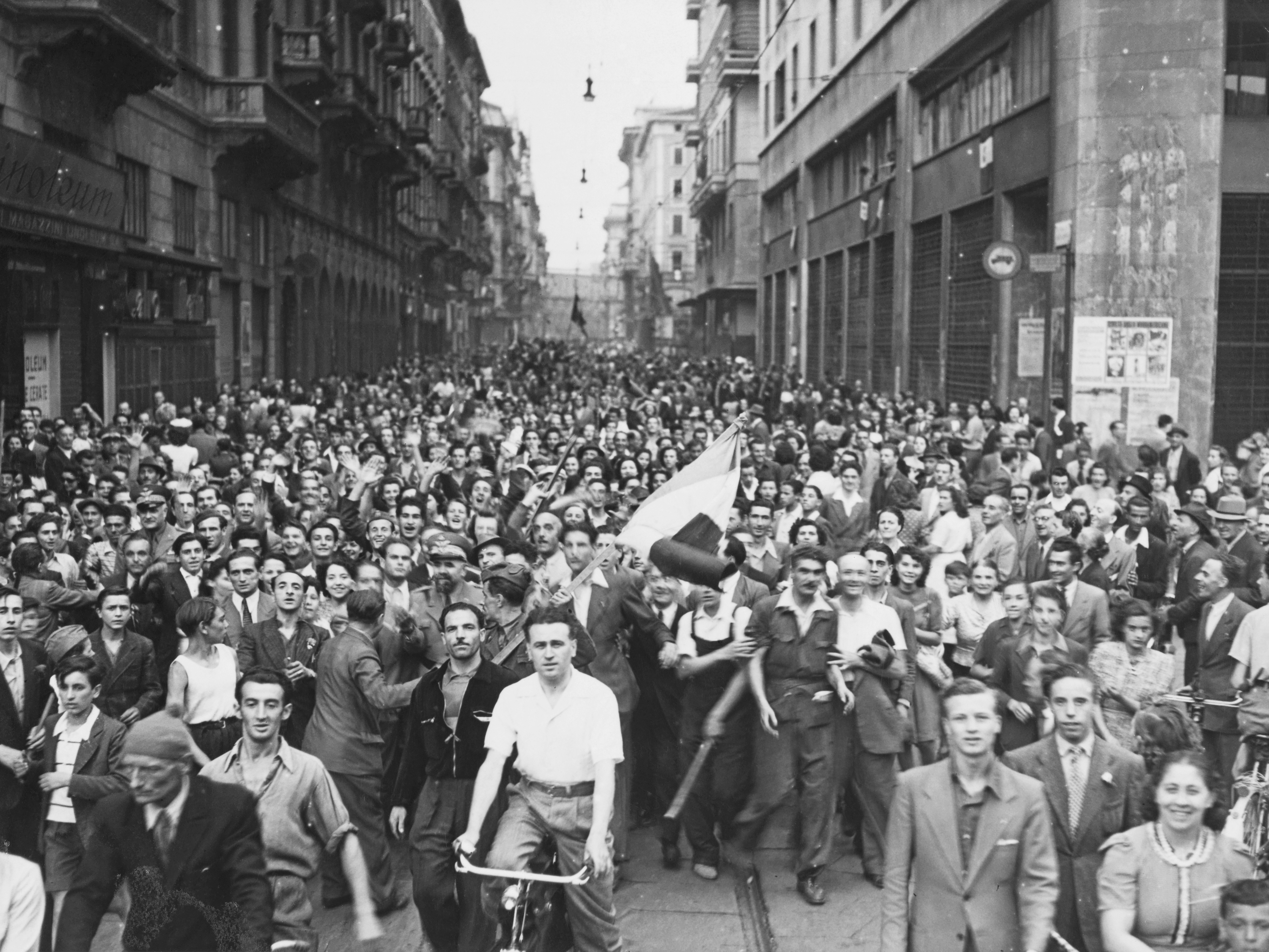caption: Civilians fill the streets of Milan, Italy, on April 25, 1945, to celebrate their liberation by Italian partisans from German Nazi forces and the fascist regime. Many believe the famous Italian anti-fascist anthem "Bella Ciao" to be associated with World War II, but the song gained widespread popularity only a few years after World War II.