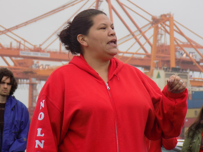caption: Puyallup Tribal Council member Anna Bean speaks at a protest against a liquid natural gas plant on the Tacoma waterfront in May 2019.