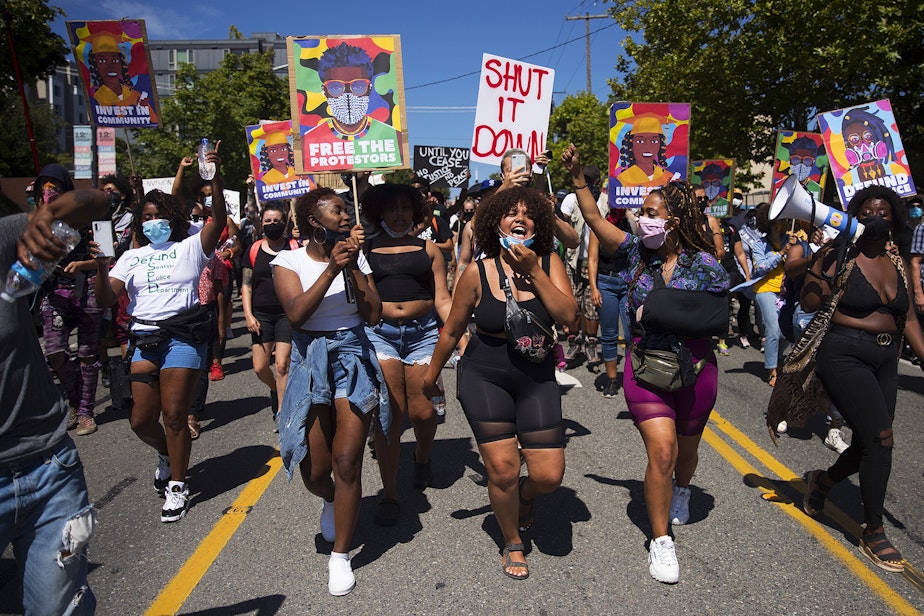 caption: Organizers of the Everyday March lead the Defund The Police march and rally with chants at the beginning of the march from the King County Juvenile Detention Center to  Seattle City Hall on Wednesday August 5, 2020, in Seattle. 