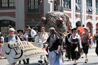 caption: Seattle atheists march in a parade. Ten percent of the city identifies as atheist, actively not believing in God. That's the highest percentage among large cities in the U.S., according to a Pew Research survey.