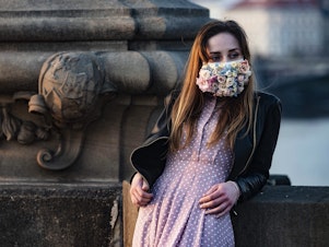 caption: A do-it-yourself mask culture is springing up in the Czech Republic. This woman was photographed on the Charles Bridge in Prague on March 28.
