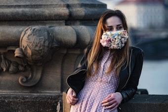 caption: A do-it-yourself mask culture is springing up in the Czech Republic. This woman was photographed on the Charles Bridge in Prague on March 28.
