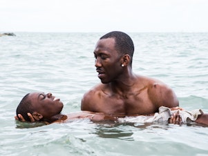 caption: Juan (played by Mahershala Ali) teaches Chiron (Jaden Piner) how to swim in <em>Moonlight</em>. The film is told with different actors playing Chiron at different stages of his life.
