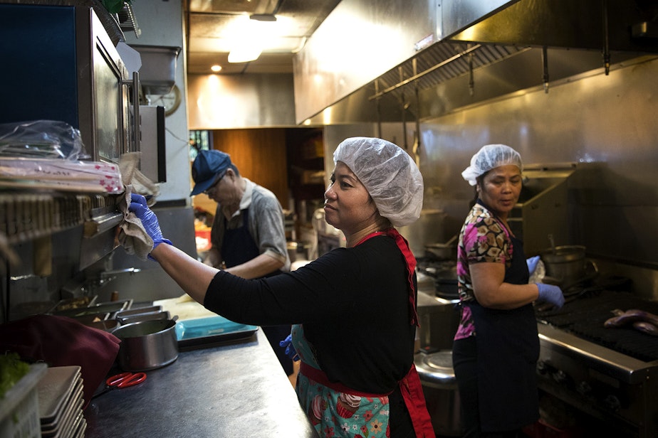 caption: Tamarind Tree employees from left, Tin Dang, Loan Luong, and Mui Tang work in the kitchen on Thursday, October 12, 2017, at the restaurant in Seattle's Little Saigon neighborhood.