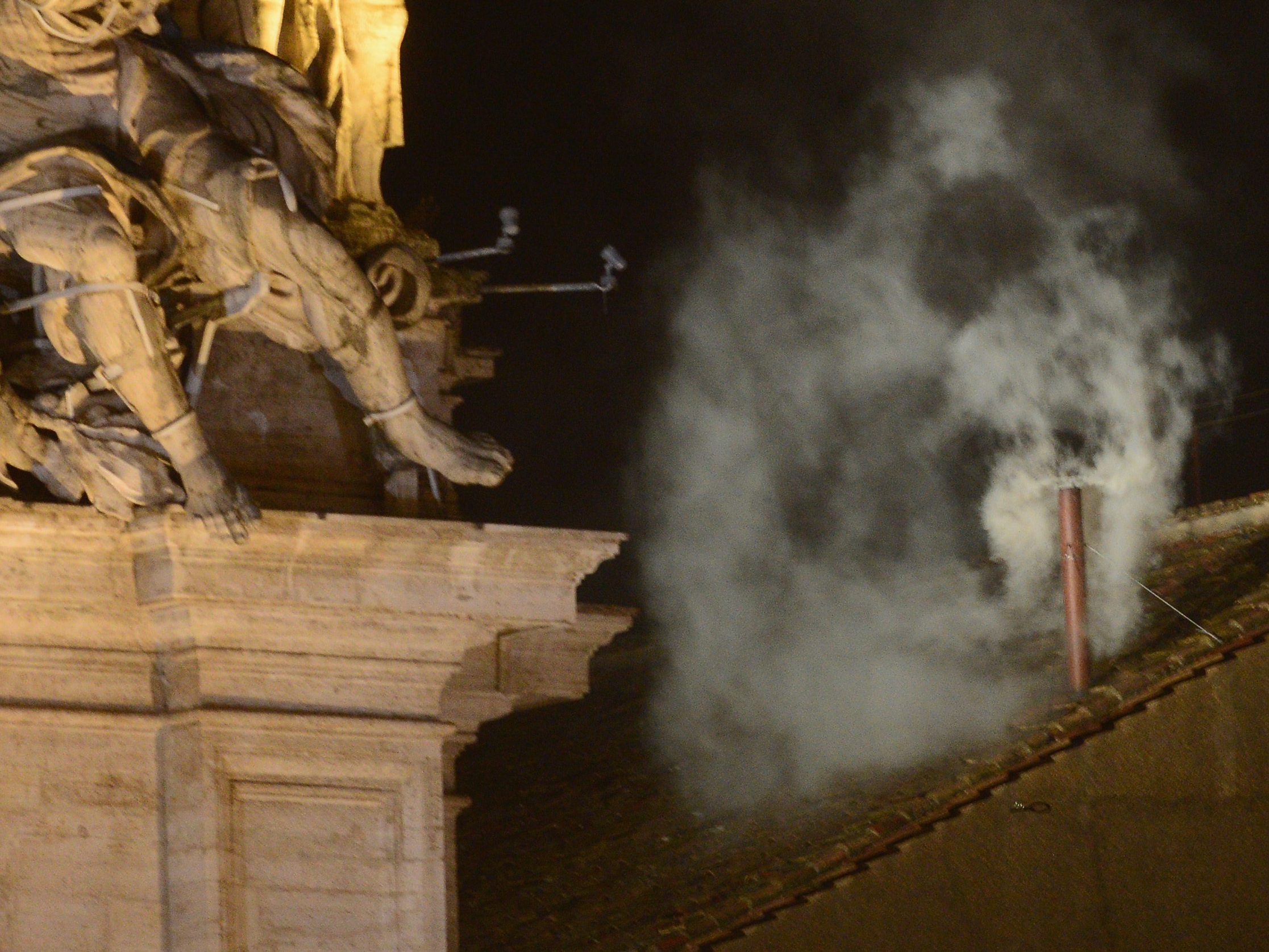 caption: White smoke billows from a chimney at the Sistine Chapel, signaling that cardinal electors have chosen a new pope — Pope Francis — on March 13, 2013.