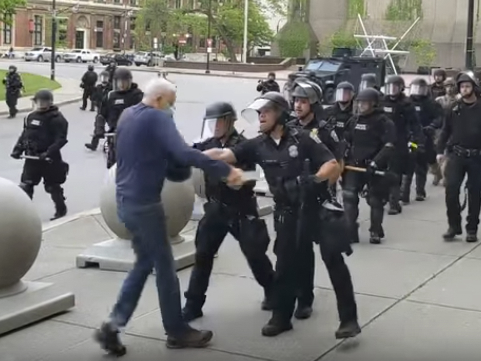caption: A video shows officers shoving an older man during a Black Lives Matter demonstration in June 2020 in Buffalo, N.Y.