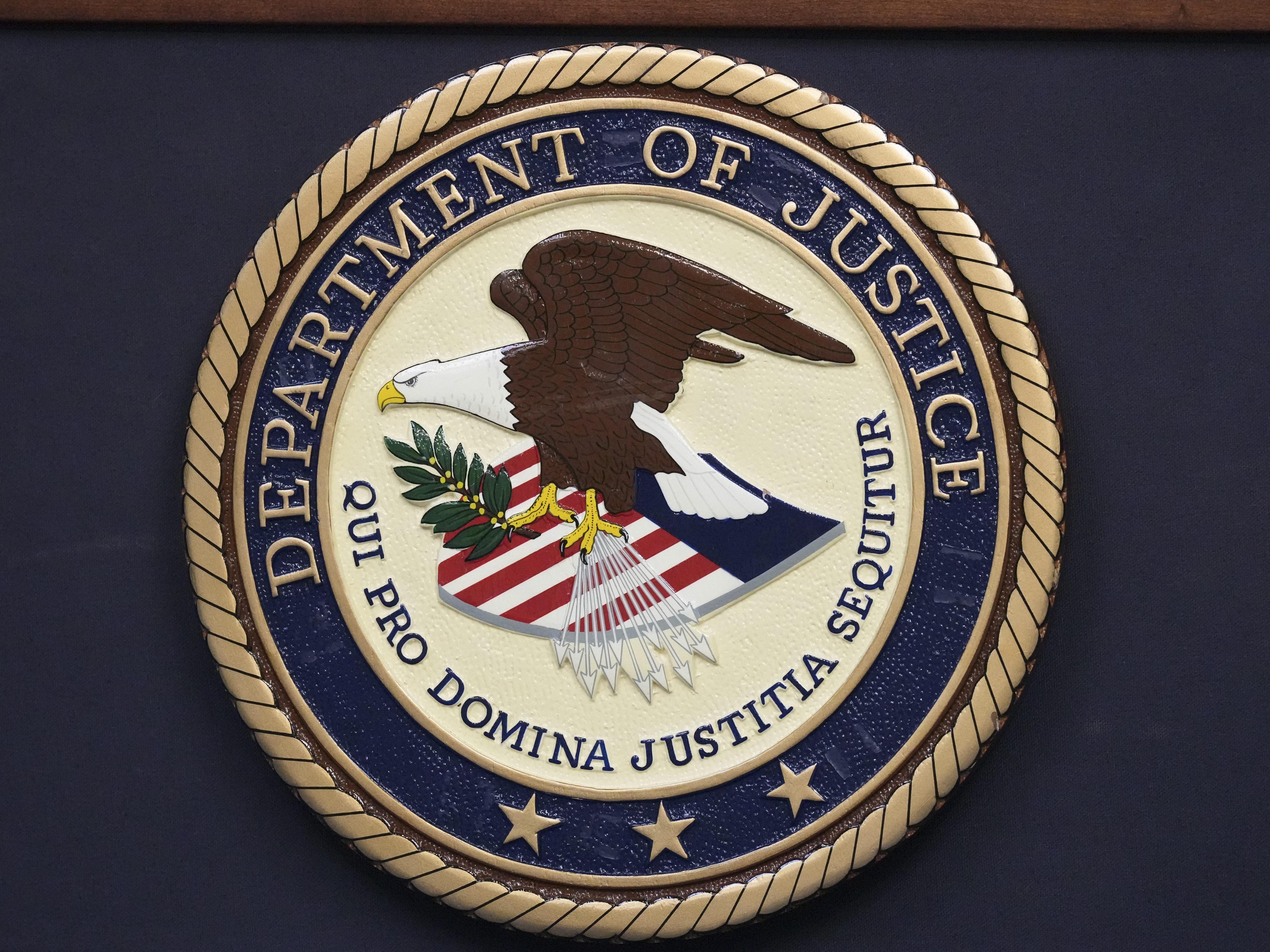 caption: The Department of Justice seal is seen during a news conference Thursday, Dec. 5, 2024, in Memphis, Tenn.