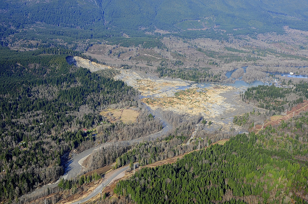 caption: The death toll continues to rise as crews search under the debris after Saturday's mudslide in Oso.