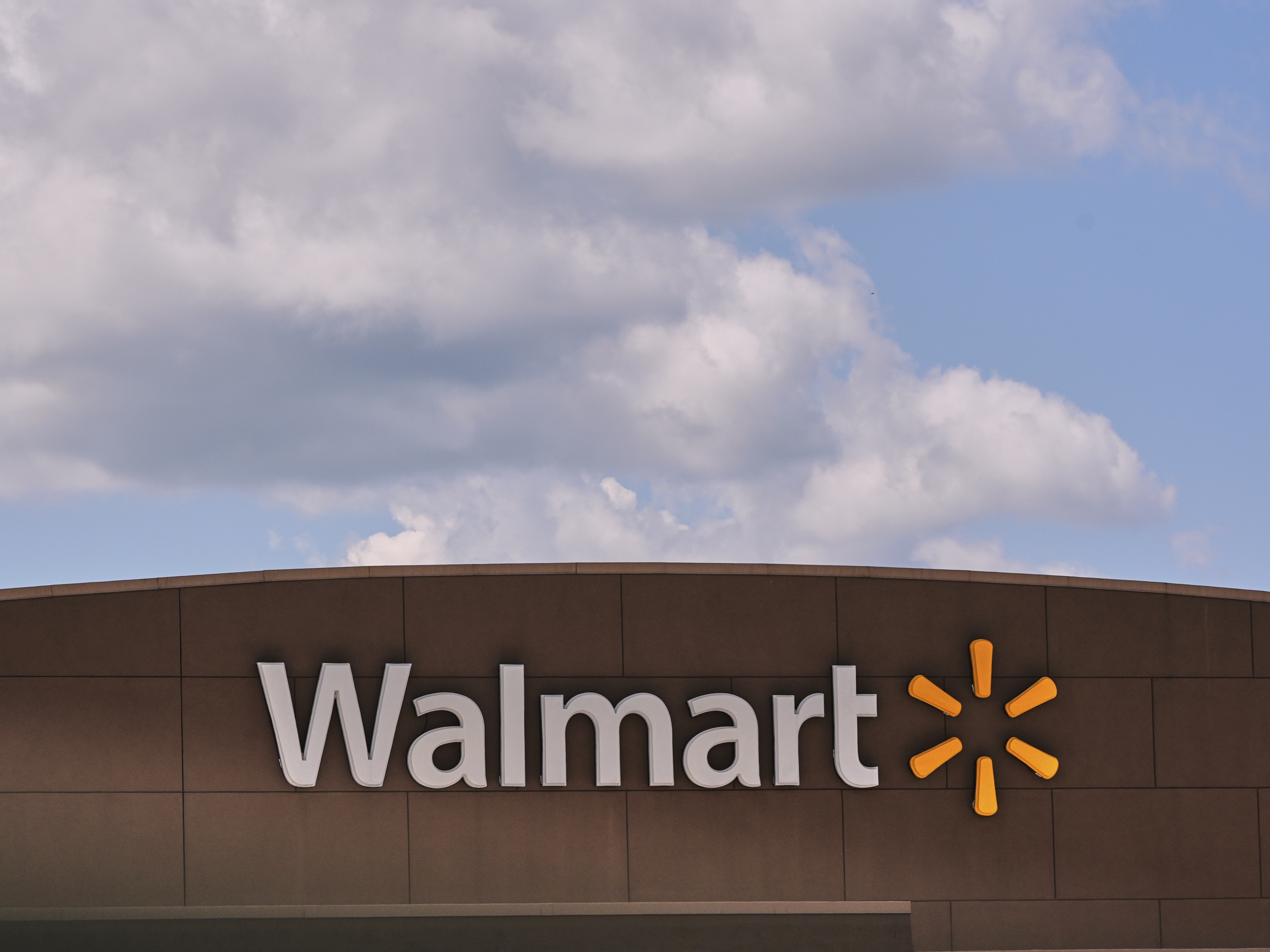 caption: Clouds pass over the Walmart store Aug. 14, 2025, in Manchester, N.H.