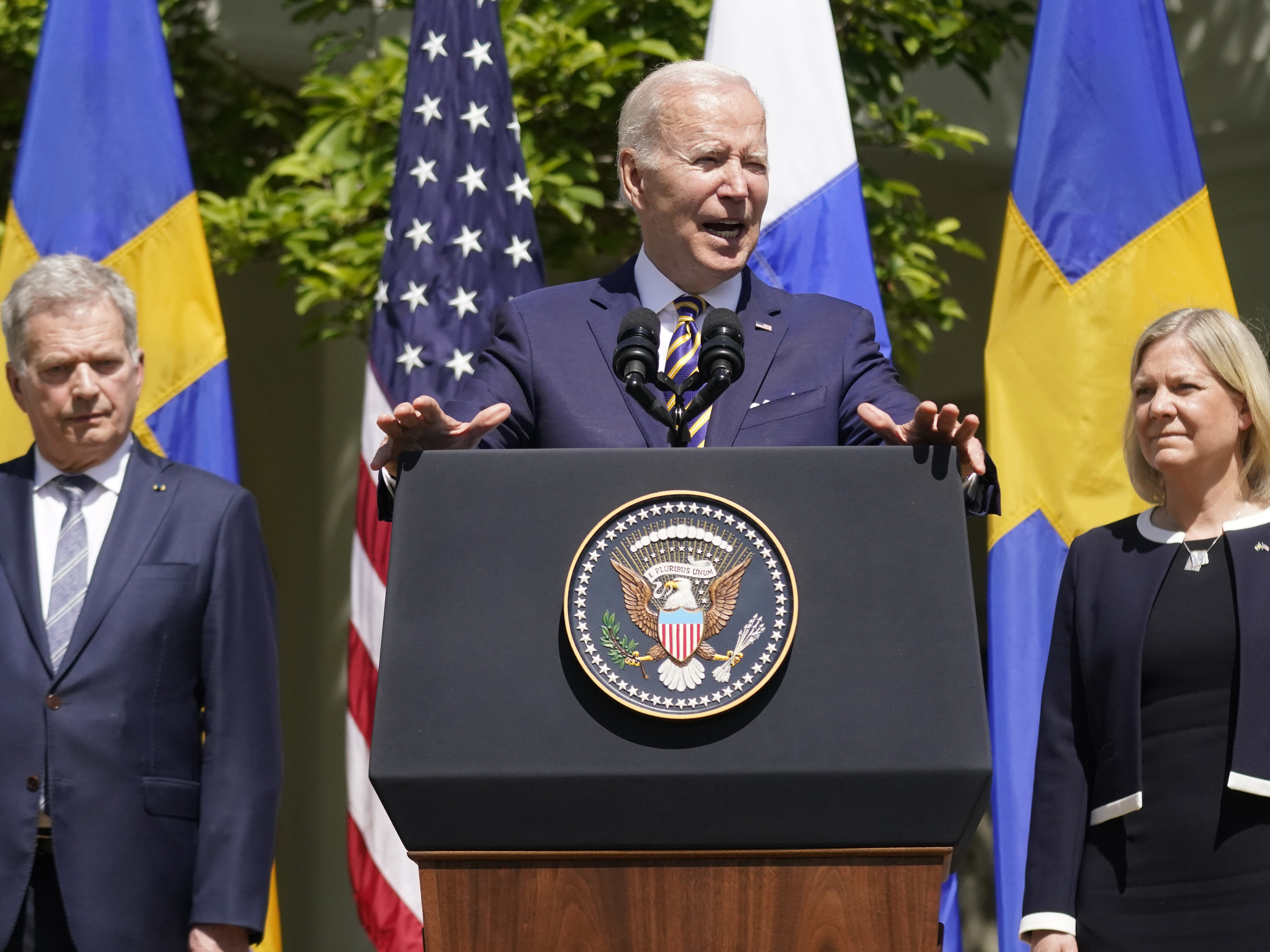 caption: President Joe Biden, standing with Swedish Prime Minister Magdalena Andersson and Finnish President Sauli Niinisto, speaks in the Rose Garden of the White House on Thursday.