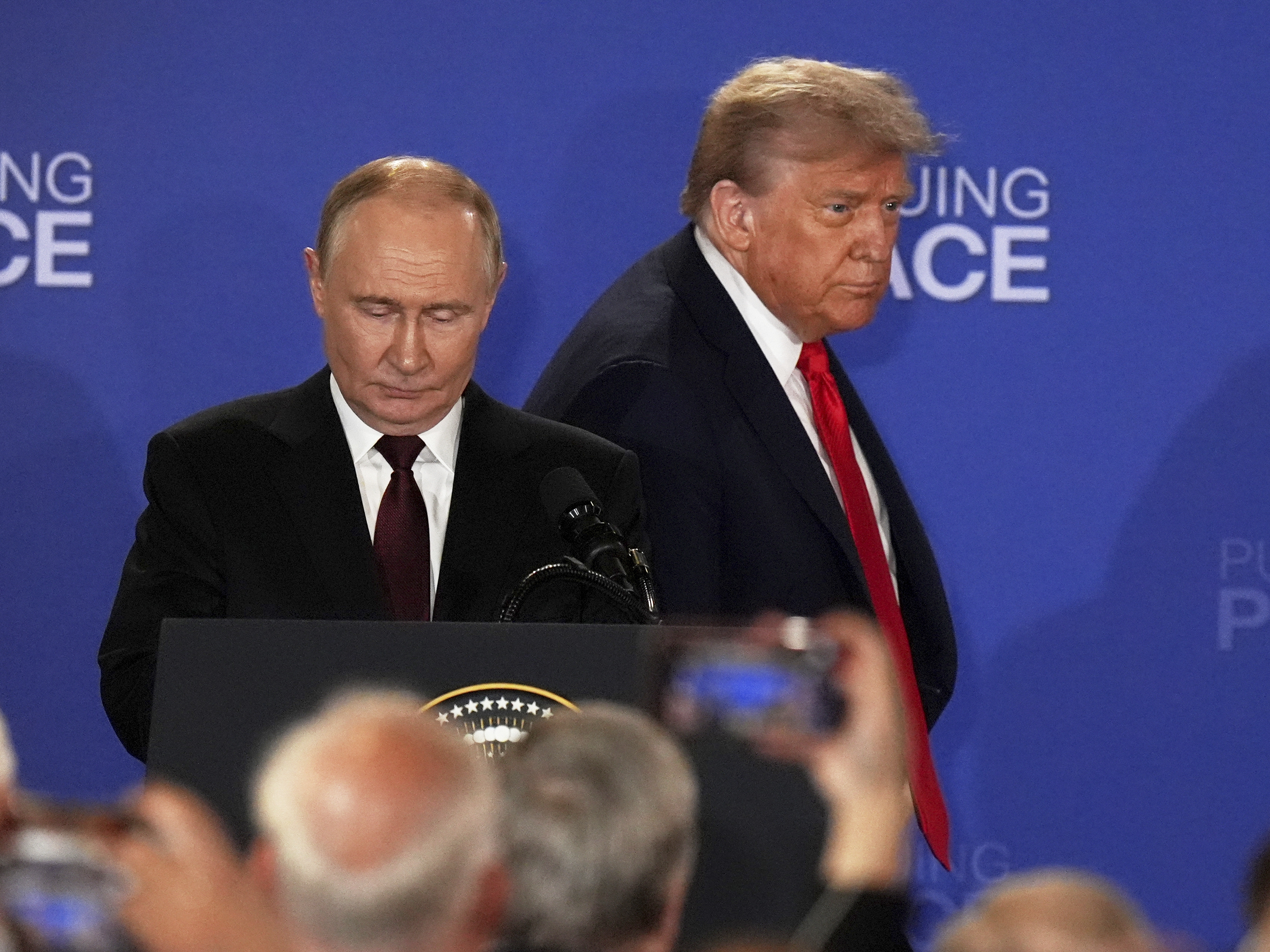 caption: President Donald Trump, right, Russia's President Vladimir Putin arrive for a joint press conference at Joint Base Elmendorf-Richardson, Alaska, Friday, Aug. 15, 2025. (AP Photo/Jae C. Hong)