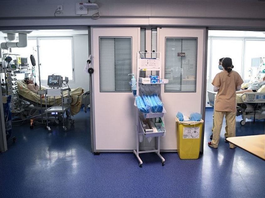caption: Medical staff tend to COVID-19 patients at the Georges Pompidou European Hospital in Paris in April.