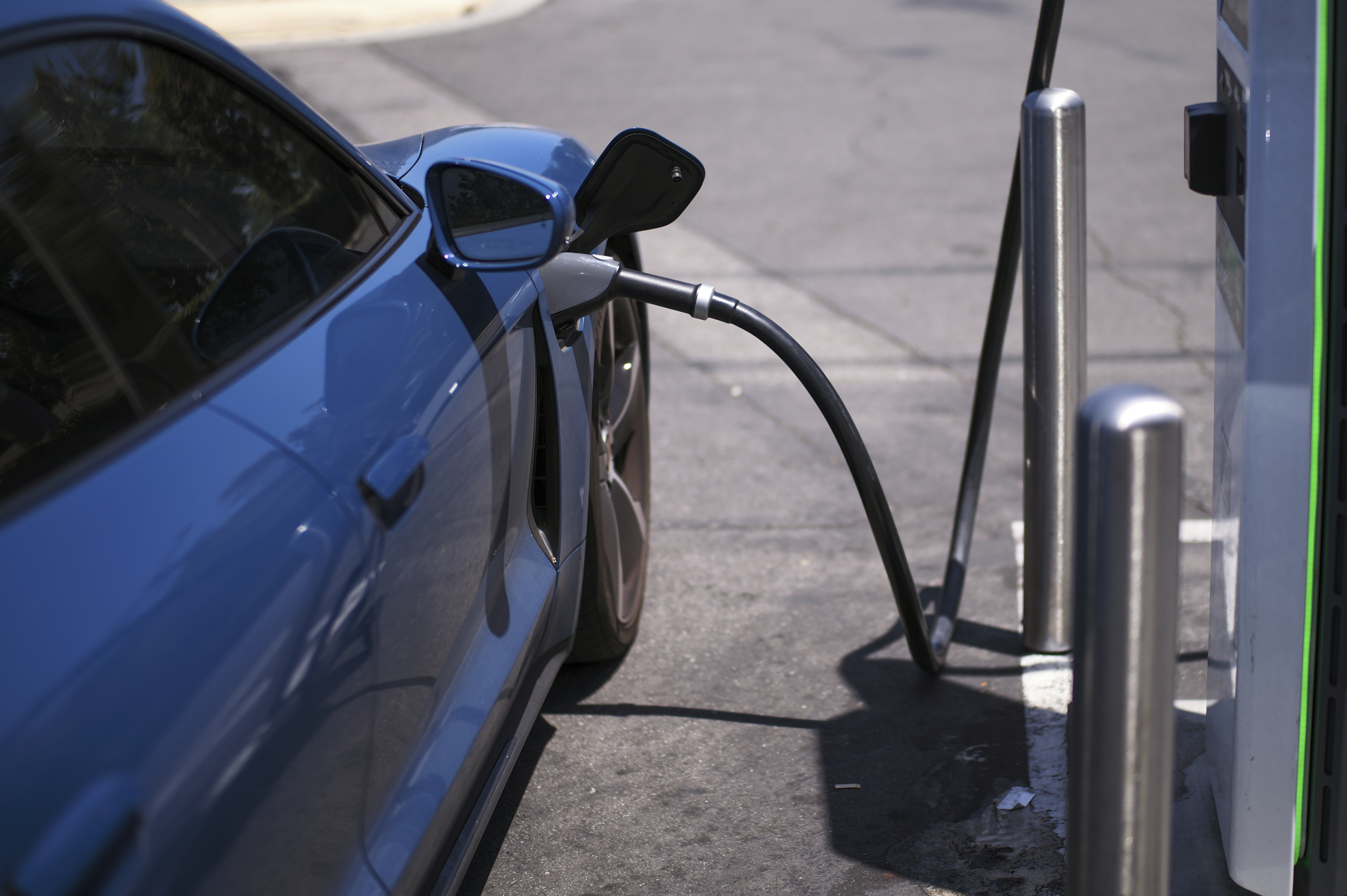 caption: FILE - An electric vehicle charges at an Electrify America station in Arcadia, Calif., May 22, 2025.
