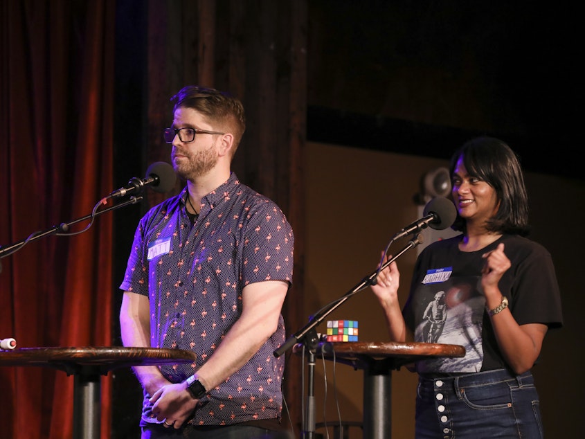 caption: Contestants compete in <em>Ask Me Another</em>'s final round at the Bell House in Brooklyn, New York.