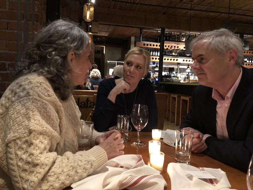 caption: Cheryl Jennings, left, her neighbor Ali Taylor, and Wes Van Voorhis at a recent Death Over Dinner event on Capitol Hill. 
