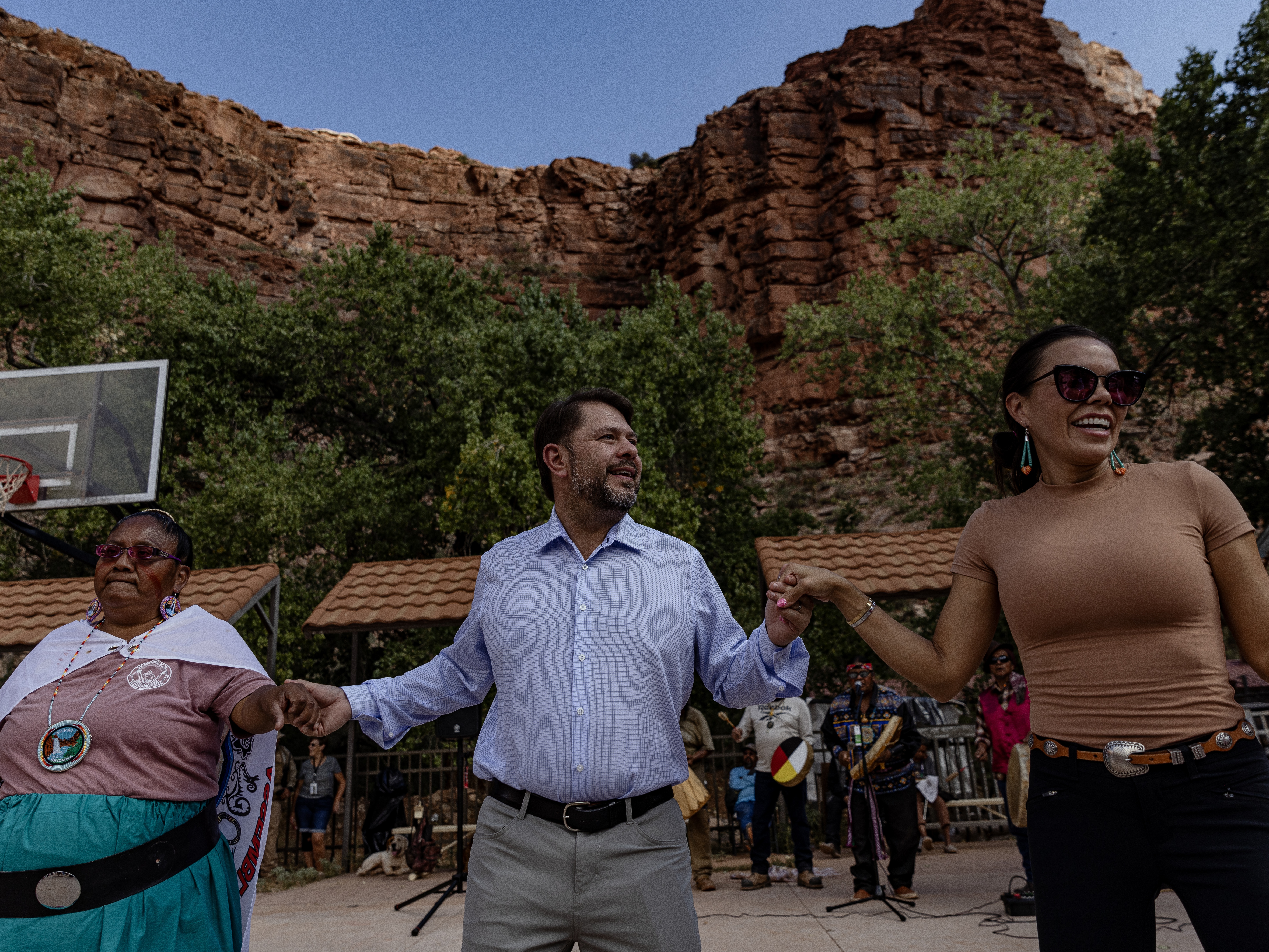 caption: Arizona Democratic Rep. Ruben Gallego (center) joins community members in a traditional dance at the Supai Tribe village in the Grand Canyon on Oct. 14.