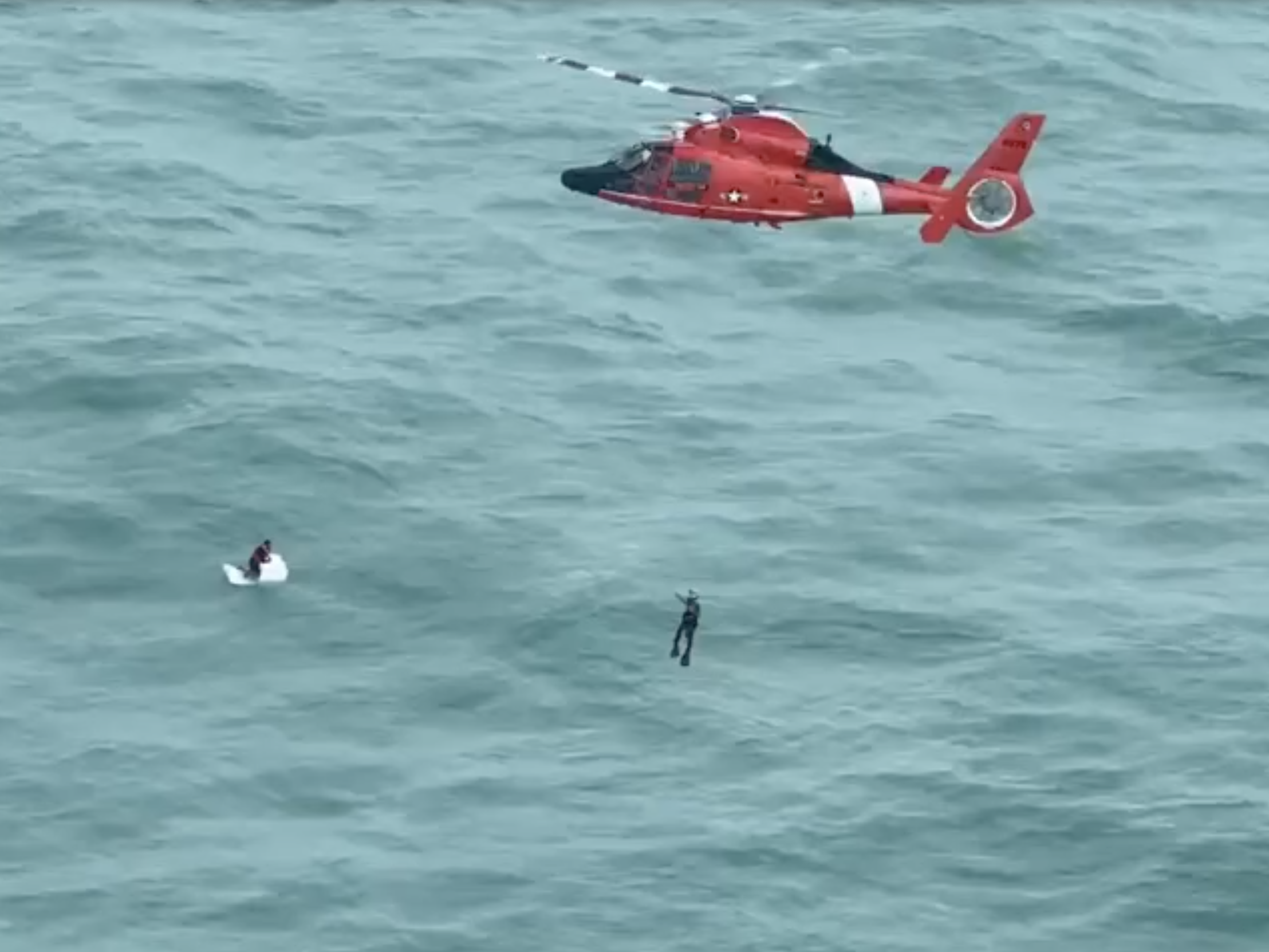 caption: A man survived a harrowing ordeal in open water as Hurricane Milton passed nearby, spending the night clinging to a large cooler before being rescued by a Coast Guard helicopter crew some 30 miles from shore.