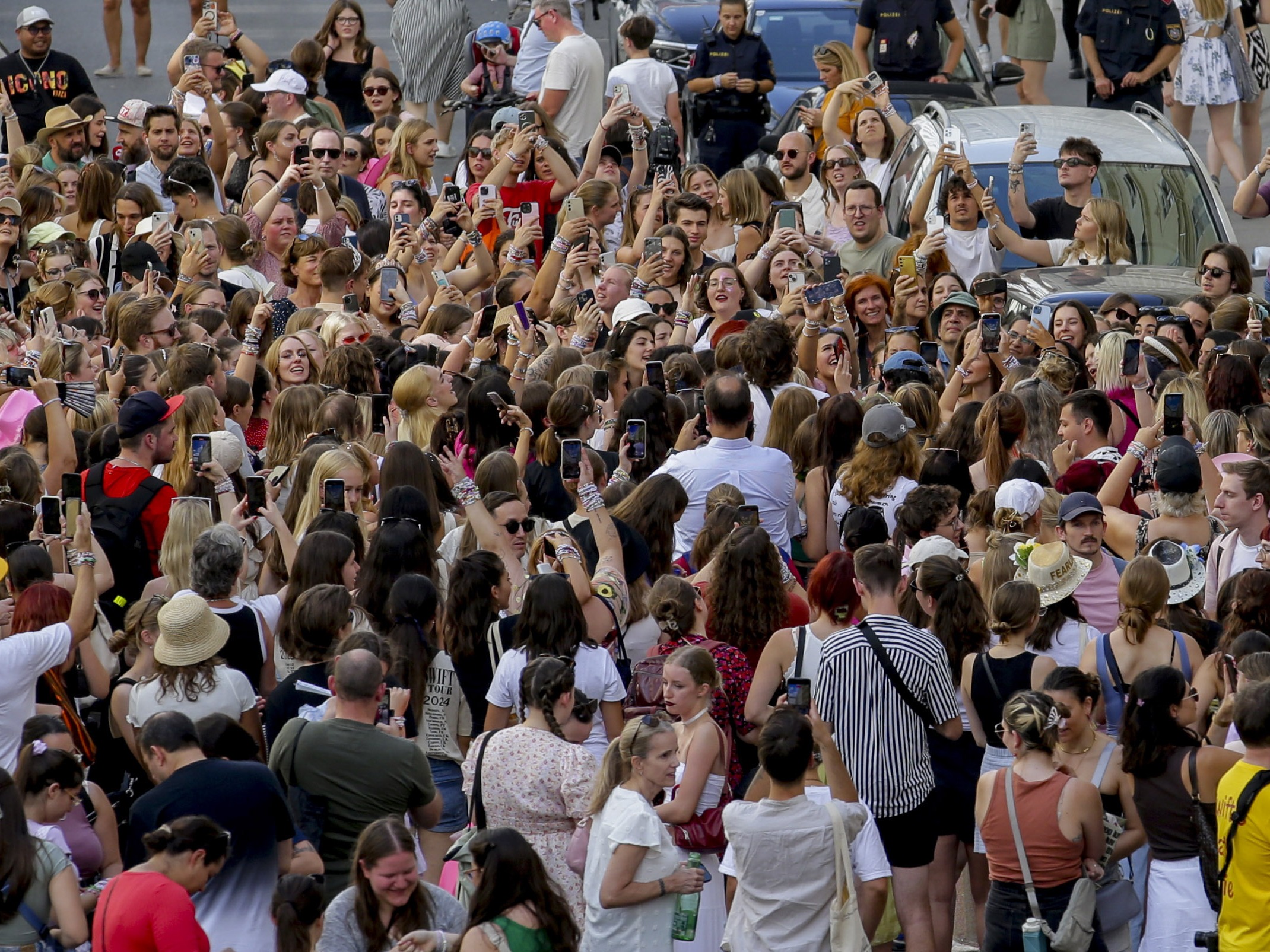 caption: Swifties gather and sing in the city center in Vienna on Thursday. Organizers of three Taylor Swift concerts in the stadium in Vienna this week called them off on Wednesday after officials announced arrests over an apparent plot to launch an attack on an event in the Vienna area such as the concerts.