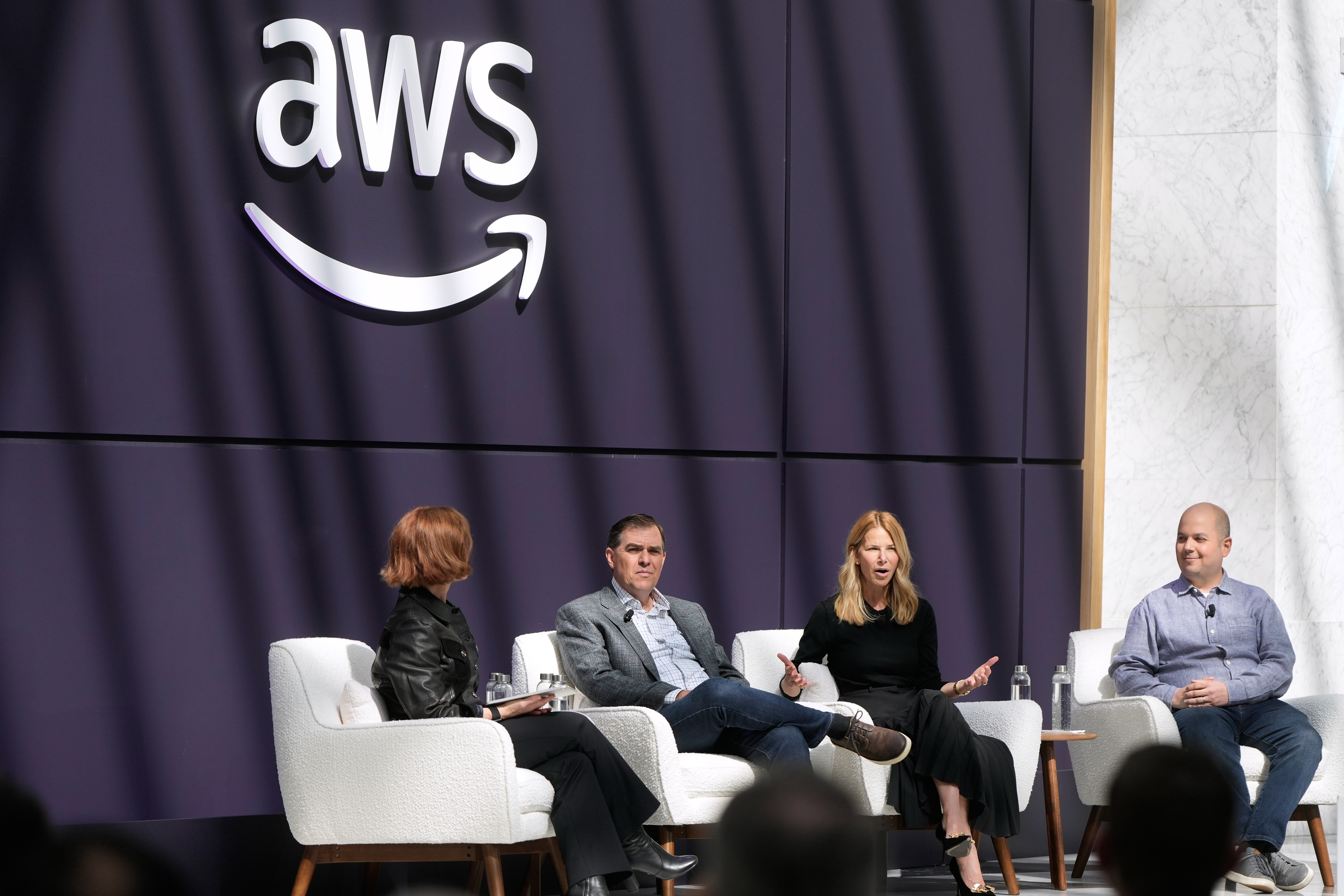 caption: Denise Dresser, chief revenue officer of OpenAI, second right, speaks on stage with Julia White, vice president & chief marketing officer, AWS, from left, Matt Garman, CEO of AWS, and Anthony Liguori, vice president and distinguished engineer, AWS, at a What's Next with AWS event, Tuesday, April 28, 2026, in San Francisco.