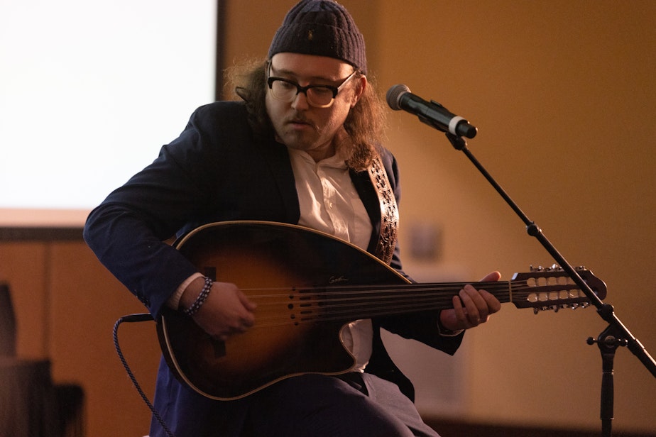 caption: Asher Shasho Levy plays an instrument called an oud,  similar to a lute.