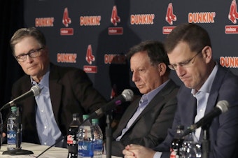 caption: (From left) Boston Red Sox owner John Henry, chairman Tom Werner and CEO Sam Kennedy during a news conference at Fenway Park, Jan. 15. The team was told Wednesday about the penalty Major League Baseball was assessing for sign-stealing in 2018.