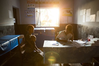 caption: A 19-year-old woman talks with nurse Valeria Zafisoa at a traveling contraception clinic in eastern Madagascar run by the British nonprofit group Marie Stopes International.