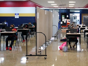 caption: A flex wall separates two groups of students in the cafeteria at Dwight D. Eisenhower Charter School in New Orleans.