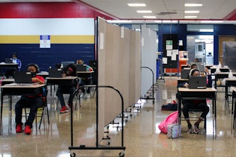 caption: A flex wall separates two groups of students in the cafeteria at Dwight D. Eisenhower Charter School in New Orleans.