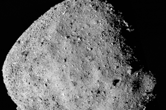 caption: This mosaic composed of images of the asteroid Bennu taken by the OSIRIS-REx spacecraft shows its surprisingly rubble-strewn surface.